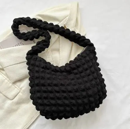 Quilted tote bag worn on shoulder casual outfit